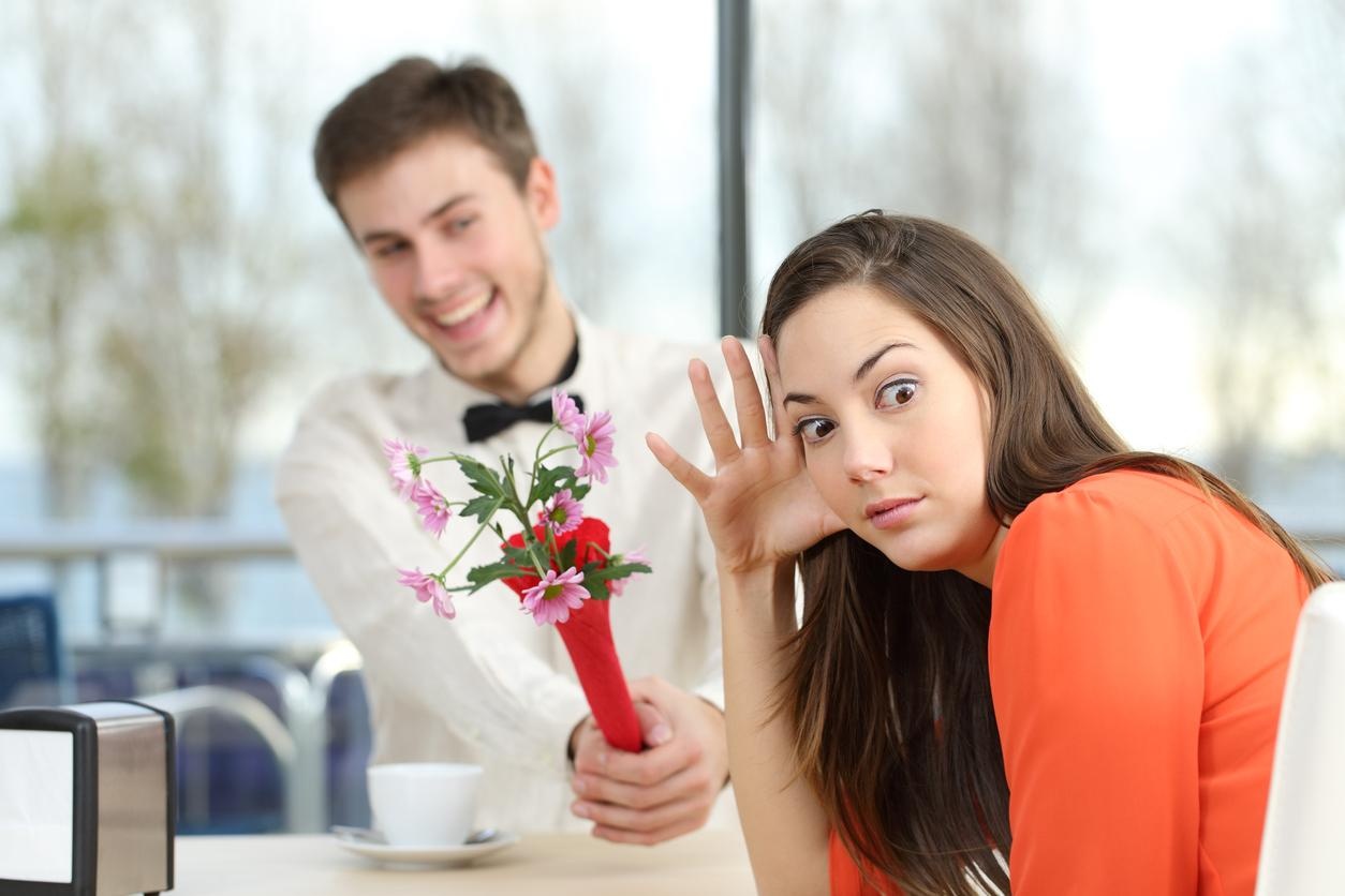 A woman standing in front of a flower